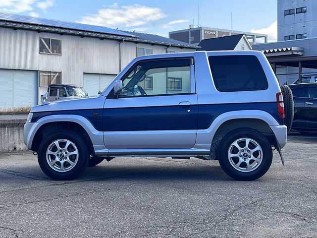 三菱 パジェロ ミニ VR 福井県 2010(平22)年 2.6万km クールシルバーM/ネアーズブルー 登録時走行距離25389ｋｍ/４WD/ターボ/ドライブレコーダー/背面タイヤ/社外15インチアルミホイール/キーレスキー/純正オーディオ/ライトレベライザー/ドアバイザー/電動格納ミラー/保証書/取扱説明書