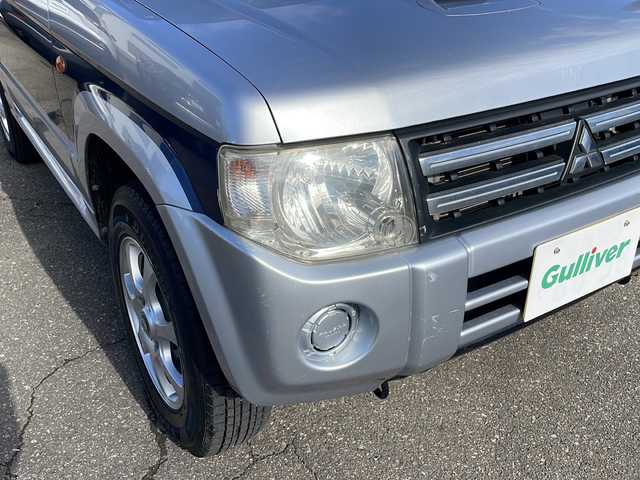 三菱 パジェロ ミニ VR 福井県 2010(平22)年 2.6万km クールシルバーM/ネアーズブルー 登録時走行距離25389ｋｍ/４WD/ターボ/ドライブレコーダー/背面タイヤ/社外15インチアルミホイール/キーレスキー/純正オーディオ/ライトレベライザー/ドアバイザー/電動格納ミラー/保証書/取扱説明書