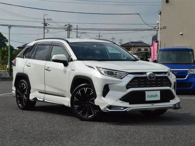 トヨタ ＲＡＶ４ ハイブリットG 栃木県 2020(令2)年 6.9万km ホワイトパールクリスタルシャイン モデリスタエアロ/・フロントスポイラー/・サイドスカート/・リヤスパッツ/モデリスタクールシャインキッド/・フロントグリルガーニッシュ/・ヘッドランプガーニッシュ/・バックドアガーニッシュ/TRD20インチアルミホイール［TRD TF X-Limited］/Toyota Safety Sense/・プリクラッシュセーフティ(歩行者[昼夜]・自転車運転/者[昼]検知機能付衝突回避支援タイプ／ミリ波レーダー＋単眼カメラ方式)/・レーントレーシングアシスト[LTA] /・レーダークルーズコントロール(全車速追従機能付)/・オートマチックハイビーム[AHB] /・ロードサインアシスト[RSA]/先行車発進告知機能[TMN]/インテリジェントクリアランスソナー[パーキングサポートブレーキ(静止物)]/リヤクロストラフィックオートブレーキ [パーキングサポートブレーキ(後方接近車両)]＋ブラインドスポットモニター[BSM]/純正9インチSDナビ［NSZT-Y68T］/・地デジ/・Bluetooth/・DVD/CD/SD/バックカメラ/運転席8ウェイパワーシート/快適温熱シート(運転席・助手席)/合皮シート/ハンズフリーパワーバックドア(挟み込み防止機能・停止位置メモリー機能付)/ETC