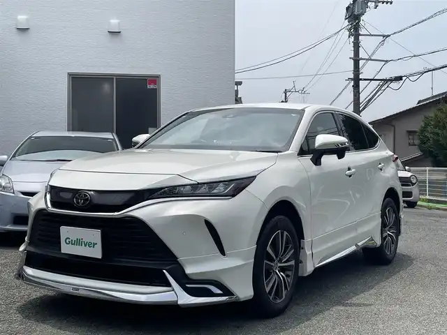 トヨタ ハリアー S 熊本県 2021(令3)年 2.8万km ホワイトパールクリスタルシャイン モデリスタエアロ/ナビ機能付きディスプレイオーディオ/【フルセグTV/BT/AM/FM/USB/AUX】/バックカメラ/トヨタセーフティセンス/・プリクラッシュセーフティ/・レーントレーシングアシスト/・クリアランスソナー/・パーキングサポートブレーキ/・ロードサインアシスト/・オートマチックハイビーム/レーダークルーズコントロール/純正18インチAW/革調シートカバー/オートホールド/前後ドライブレコーダー/ＬＥＤヘッドライト/オートライト/ヘッドライトレベライザー/ビルトインＥＴＣ/革巻きステアリング/ステアリングリモコン/社外フロアマット/取扱説明書/保証書