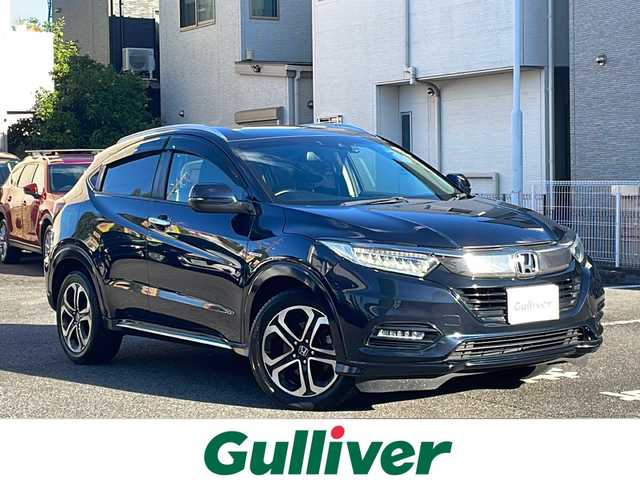 ホンダ ヴェゼル ハイブリッド Z ホンダセンシング 愛知県 2019(令1)年 16.6万km ミッドナイトブルービームM /ワンオーナー//禁煙車//純正ナビ・フルセグTV//Bluetooth・CD・DVD・AM・FM//スマートキー×２//保証書・取説//LEDフォグライト//カラードボディーロアーガーニッシュ//全ドアワンタッチ式パワーウインドウ//コンビシート＆専用インテリア//ラゲッジルームハードボード//運転席＆助手席シートヒーター//ルーフレール（FF）//パフォーマンスダンパー(R)//リバース連動ドアミラー（助手席側）//本革巻ステアリングホイール（スムースレザー）//雨滴検知式フロントワイパー//プラチナクロームメッキ加飾//17インチアルミホイール（スポーツタイプ）//エキパイフィニッシャー//自動防眩ルームミラー//前席用i-サイドエアバッグシステム＋サイドカーテンエアバッグシステム〈前席/後席対応〉//Honda SENSING//LEDヘッドライト〈インラインタイプ〉//左右独立温度コントロール式フルオート//エアコンディショナー//リアクティブフォースペダル//ハイブリッド専用デザインメーター//ナビ装着用スペシャルパッケージ＋ETC車載器//電子制御パーキングブレーキ//オートブレーキホールド機能