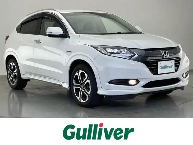 ホンダ ヴェゼル ハイブリッド 愛知県 2016(平28)年 5.7万km ホワイトオーキッドパール 純正7型ナビ/Bluetooth/フルセグテレビ/CD/DVD/ETC/バックカメラ/オートクルーズコントロール/LEDヘッドライト/ホンダセンシング/ハーフレザーシート/シートヒーター/禁煙車