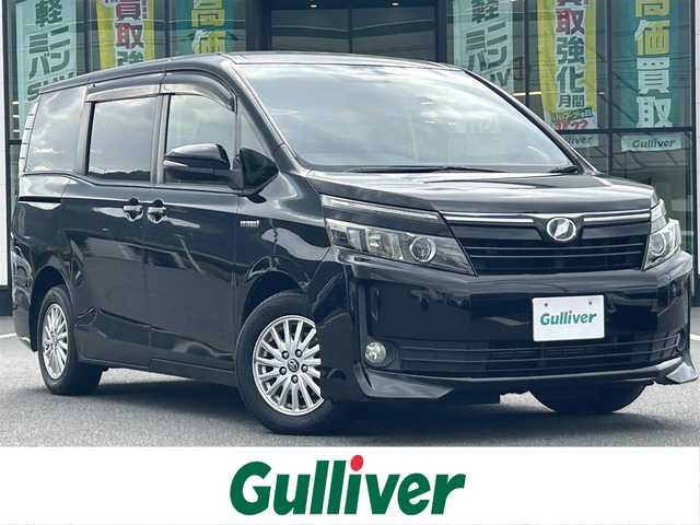 トヨタ ヴォクシー ハイブリッド V 岡山県 2014(平26)年 14.6万km ブラック 登録時走行距離145516km/アルパイン10インチナビ/フルセグTV(AM.FM.CD.DVD.TV.BT)/両側スライドドア/パワースライドドア/バックカメラ/ETC/シートヒーター/衝突軽減ブレーキ/横滑り防止装置/クルーズコントロール/オートライト/アイドリングストップ/15インチ純正AW/純正フロアマット/スマートキー/スペアキー/プッシュスタート