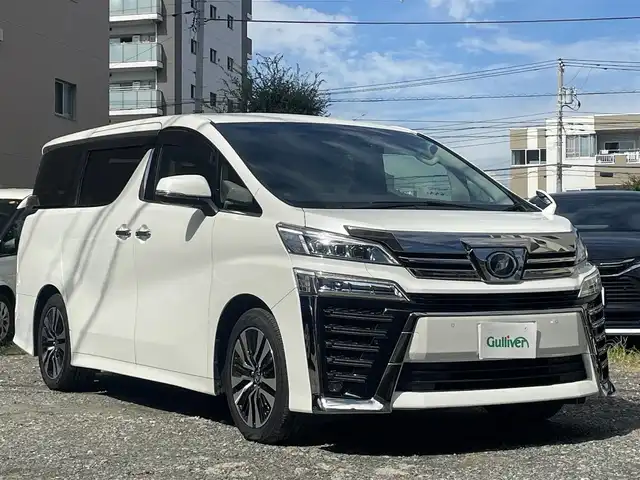 トヨタ ヴェルファイア Z Gエディション 東京都 2019(令1)年 4.4万km ホワイトパールクリスタルシャイン 純正SDナビ/ (フルセグTV/Bluetooth/DVD/SD)/バックカメラ/ビルトインETC2.0/前後ドライブレコーダー/両側パワースライドドア/デジタルインナーミラー/レザーシート/前席パワーシート【運転席メモリ機能あり】/前席シートヒーター/エアシート/オットマンシート/3列シート/パワーバックドア/ステアリングヒーター/TOYOTA Safety Sense/・レーダークルーズ コントロール/・プリクラッシュセーフティ/・レーントレーシングアシスト/・レーンディパーチャーアラート/・ロードサインアシスト/・先行車発進告知機能/・オートマチックハイビーム/ブラインドスポットモニター/横滑り防止装置/スマートキー/純正18インチアルミホイール/純正LEDヘッドライト/カーテンエアバック/スペアキー1本/保証書/取扱説明書