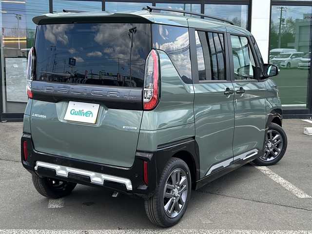 三菱 デリカミニ T プレミアム 道東・釧路十勝 2025(令7)年 0.1万km未満 緑 ・4WD/・純正9インチディスプレイオーディオ/(Android・AU to car play・BT・FM・AM)/・全方位カメラ＋バックカメラ/・追従式クルーズコントロール/・衝突被害軽減システム/・車線逸脱警報/・車線逸脱防止支援/・アクティブスタビリティコントロール/・先行車発進お知らせ/・速度標識表示道路標識表示/・ふらつき警報/・ヒルディセントコントロール/・両側パワースライドドア/・オートスライドドア/・LEDヘッドライト/・フォグライト/・オートライト/・オートマチックハイビーム/・ヘッドライトレベライザー/・ステアリングヒーター/・ステアリングヒーター/・ステアリングスイッチ/・アイドリングストップ/・電格ウィンカーミラー/・スマートキー