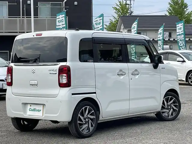 スズキ ワゴンＲ スマイル HYBRID X 宮城県 2023(令5)年 1.6万km ピュアホワイトP /4WD//純正9インチメモリナビ//CD/DVD/BT/HDMI/フルセグテレビ//AppleCarPlay/AndroidAuto//両側パワースライドドア//シートヒーターDN席//ヘッドアップディスプレイ//ビルトインETC//op純正15インチアルミホイール//純正フロアマット//デュアルカメラブレーキサポート//アラウンドビューモニター//レーントレーシングアシスト//レーダークルーズコントロール//パーキングセンサー//アイドリングストップ//スマートキーx2//社外14インチアルミスタッドレスタイヤ積込（2022年製）