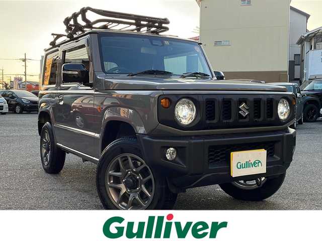 スズキ ジムニー XC 新潟県 2023(令5)年 0.7万km ミディアムグレー ワンオーナー/MT車/衝突軽減ブレーキ/レーンキープアシスト/アイドリングストップ/社外SDナビ（Panasonic CN-RZ743W)/(CD/DVD/フルセグTV/Bluetooth）/ETC/スマートキー×2/革巻きステアリング/クルーズコントロール/ステアリングリモコン/シートヒーター/LEDヘッドライト/オートライト/オートエアコン/フォグランプ/TERZO製ルーフキャリア/純正16インチAW/純正フロアマット/ドアバイザー/保証書/取扱説明書/ナビ取扱説明書