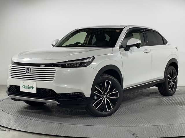 ホンダ ヴェゼル ハイブリッド e:HEV Z 広島県 2025(令7)年 0.1千km プラチナホワイトパール 登録済未使用車　４Km/純正９型ナビ/バックカメラ/シートヒーター(運転席/助手席)/レーダークルーズコントロール/ＥＴＣ2.0/ワイヤレス充電/ステアリングヒーター/ブラインドスポットモニター/電動リアゲート/アダブティブLEDヘッドライト/衝突被害軽減/レーンキープアシスト/踏み間違い防止/エアバッグ(運転席/助手席/サイド/カーテン)/純正18インチアルミホイール(225/50/R18)