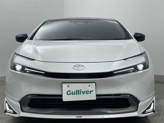 トヨタ プリウス Z 岡山県 2024(令6)年 0.4万km プラチナホワイトパールマイカ パノラマガラスルーフ/モデリスタエアロ（前・横・後下）	/純正１２．３インチディスプレイオーディオ	/【ナビ/フルセグ/Bluetooth/Carplay】	/パノラミックビューモニター	/追従型クルーズコントロール	/オートハイビーム	/LEDヘッドライト（AUTO機能付き）	/ビルトインETC２．０/デジタルインナーミラー/前席シートヒーター	/ステアリングヒーター/前席エアシート/運転席パワーシート	/衝突軽減ブレーキシステム	/車線逸脱防止システム	/横滑り防止装置/踏み間違い防止装置	/ブラインドスポットモニター/オートブレーキホールド/純正ドライブレコーダー（前後）	/純正19インチアルミ	/コーナーセンサー（前後）	/純正フロアマット	/ステアリングスイッチ	/ISOFIX/チルトステアリング/シートリフター/ウィンカーミラー/ドアバイザー/プッシュスタート	/新車保証書/スペアキー×1
