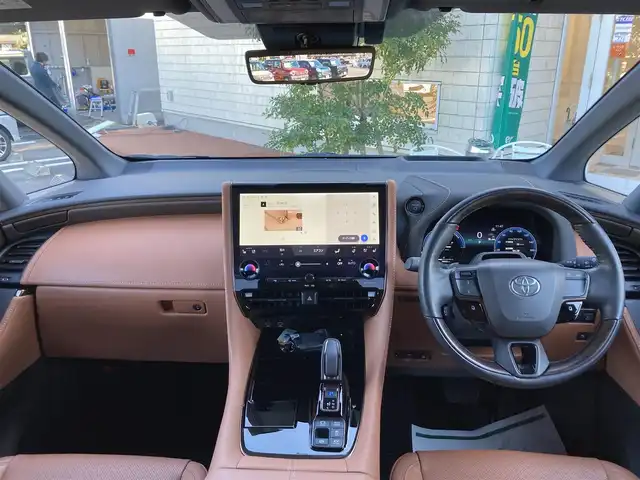 トヨタ ヴェルファイア ハイブリット Z プレミア 愛媛県 2023(令5)年 1.7万km ブラック メーカーオプションナビ/・フルセグTV/UBS/Bluetooth/置くだけ充電/全方位モニター/・バック/フロントカメラ/フリップダウンモニター/サンルーフ/両側パワースライドドア/ユニバーサルステップ/パワーバックドア/2列目電動サンシェード/デジタルインナーミラー/茶革シート/・D/Nパワーシート/・Dメモリーシート/・全席シートヒーター/エアーシート/・2列目電動リクライニング/オットマンシート/ステアリングヒーター/ETC2.0/パドルシフト/衝突軽減ブレーキ/レーンキープアシスト/レーダークルーズコントロール/クリアランスソナー/パーキングサポートブレーキ/ロードサインアシスタント/安心降車アシスト/アドバンスドパーキング/LEDオートライト/・オートハイビーム/ヘッドアップディスプレイ