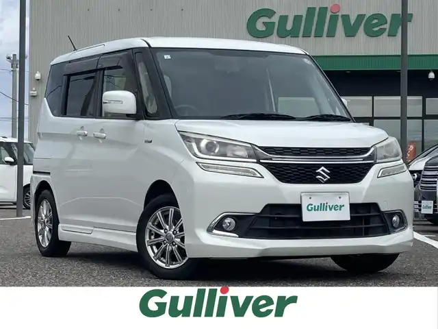 スズキ ソリオ バンディット HV MV Dカメラ ブレーキS 島根県 2017(平29)年 7.8万km ピュアホワイトP ワンオーナー /4WD/社外メモリナビ (CD/DVD/BT/フルセグ)/バックカメラ/両側パワースライドドア /衝突被害軽減ブレーキ/車線逸脱警報/クルーズコントロール/オートライト/前席シートヒーター /ステアリングリモコン/アイドリングストップ/電動格納ミラー/ミラーウィンカー/純正フロアマット/純正ドアバイザー/取扱説明書/保証書/スペアキー×1