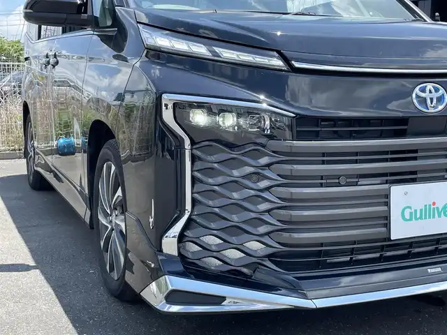 トヨタ ヴォクシー ハイブリッド S－Z 茨城県 2024(令6)年 0.3万km アティチュードブラックマイカ 純正ナビ/【AM・FM・TV・BT・USB】/シートヒーター/100V電源/レーダークルコン/Bカメラ/ETC2.0/前後コーナーセンサー/フロントエアロパーツ/両側パワスラ/ブレーキホールド/オートライト/オートハイビーム/LEDライト/純正フロアマット/純正アルミホイール/横滑り防止装置/レーンキープアシスト/衝突被害軽減システム/ステリモ