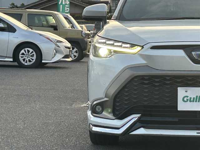 トヨタ カローラ クロス ハイブリッド Z 広島県 2023(令5)年 7万km プラチナホワイトパールマイカ ワンオーナー/純正メモリナビ/　（Bluetooth/フルセグテレビ/AM/FM）/レーダークルーズコントロール/モデリスタエアロ/全方位モニター/ブラインドスポットモニター/電子パーキング/オートブレーキホールド/ビルトインETC/パワーシート/シートヒーター/純正18インチアルミホイール/ルーフレール/純正フロアマット/コーナーセンサー/レーンキープアシスト/横滑り防止装置/衝突被害軽減システム/オートマチックハイビーム/LEDヘッドライト/フォグランプ/カーテンエアバック/スペアキー/保証書/取扱説明書