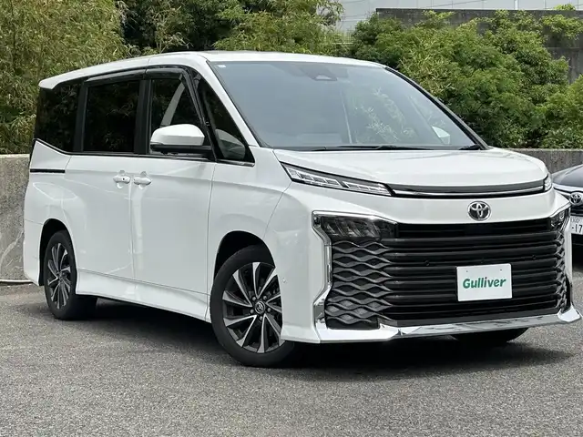 トヨタ ヴォクシー S－Z 愛知県 2023(令5)年 1.7万km ホワイトパールクリスタルシャイン ワンオーナー/純正ディスプレイオーディオ/・ナビ/AM/FM/BT/フルセグTV/HDMI/バックカメラ/全方位カメラ/両側パワースライドドア/パワーバックドア/フリップダウンモニター/前席シートヒーター/2列目シートヒーター/2列目オットマン/ステアリングヒーター/ステアリングスイッチ/追従クルーズコントロール/オートライト/オートハイビーム/MT付AT/LDA/PCS/PDA/コーナーセンサー/RCD/PKSB/RSA/フロアマット/ドアバイザー/ビルトインETC2.0/取扱説明書/ナビ取扱説明書/スペアキー/保証書