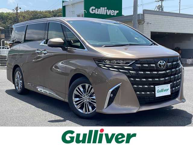 トヨタ アルファード Z 山口県 2025(令7)年 0.1万km 茶 カラー：4Y7（プレシャスレオブロンド）/登録時走行距離102km/左右独立ムーンルーフ/ユニバーサルステップ/デジタルインナーミラー/トヨタチームメイト/黒レザーシート/純正ナビ/Bluetooth/フルセグTV/全周囲カメラ/両側パワースライドドア/パワーバックドア/ヘッドアップディスプレイ/ブラインドスポットモニター/HDMI接続端子（コンソール内）/置くだけ充電/トヨタセーフティセンス/LEDヘッドライト/LEDフォグライト/オートマチックハイビーム/1列目2列目シートヒーター/1列目2列目ベンチレーションシート/ビルトインETC2.0/純正フロアマット/保証書・取説/スペアキー1個