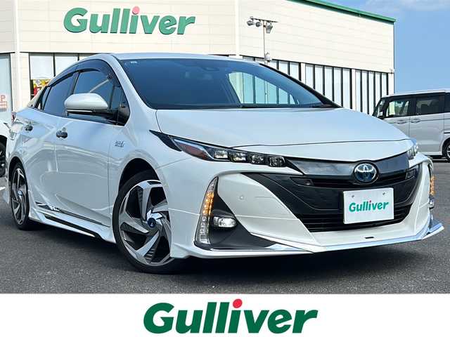 トヨタ プリウス ＰＨＶ A プレミアム 佐賀県 2019(令1)年 11.3万km ホワイトパールクリスタルシャイン ・モデリスタエアロ/・モデリスタアルミ/・純正9インチナビ/（フルセグ/Bluetooth/DISC/AM/FM/SD）/・バックカメラ/・ドライブレコーダー/・衝突被害軽減システム/・横滑り防止装置/・追従型クルーズコントロール/・レーンキープアシスト/・パーキングアシスト/・LEDヘッドライト/・フォグランプ/・ビルドインETC/・D席パワーシート/・D/N席エアシート/・D/N席シートヒーター/・ヘッドアップディスプレイ/・スペアキー