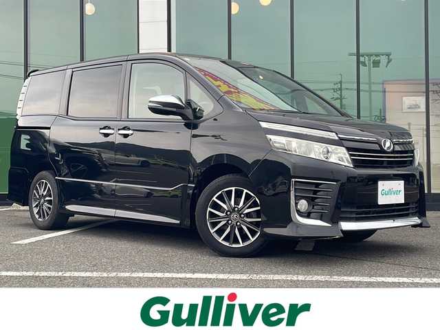 トヨタ ヴォクシー ZS 煌 福岡県 2015(平27)年 8.3万km ブラック ＡＬＰＩＮＥ１０型メモリナビ／ＥＸ１０００/フルセグＴＶ／Bluetooth/CD/DVD/バックカメラ/前後ドライブレコーダー/両側パワースライドドア/ビルトインＥＴＣ/純正１６インチアルミホイール/ＬＥＤヘッドライト/ステアリングスイッチ/プッシュスタート/スマートキー/スペアキー