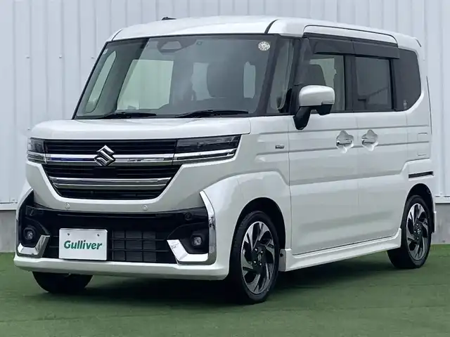 スズキ スペーシア カスタム HYBRID XS 香川県 2024(令6)年 1.2万km ピュアホワイトP 登録時走行距離：11824km/メーカー純正メモリナビ/　CD DVD BT フルセグTV/全方位カメラ/両側パワースライドドア/デュアルセンサーブレーキサポート/レーンキープアシスト/レーダークルーズコントロール/ヘッドアップディスプレイ/クリアランスソナー/LEDヘッドライト/オートライト/フォグランプ/前後ドライブレコーダー/ビルトインETC2.0/ハーフレザーシート/シートヒーター/革巻きステアリング/ステアリングヒーター/電子パーキングブレーキ/後席ロールサンシェード/サーキュレーター/アイドリングストップ/横滑り防止装置/プッシュスタート/スマートキー/スペアキー/新車時保証書/取扱説明書
