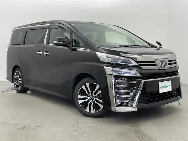トヨタ ヴェルファイア Z Gエディション 富山県 2018(平30)年 2万km バーニングブラッククリスタルシャインガラスフレーク 純正10型ナビ（AM/FM/DVD/BT）/バックカメラ/純正12型後席モニター/両側パワースライドドア/パワーバックドア/ドライブレコーダー/ETC/レザーシート/D/N席パワーシート/D席メモリシート/シートヒーター/エアシート/ハンドルヒーター/衝突被害軽減システム/レーダークルーズコントロール/レーンキープアシスト/横滑り防止装置/純正アルミホイール/純正フロアマット/オートLEDライト/フォグライト/オートホールド付電子パーキング/ウッドコンビステアリング/ステアリングスイッチ/スマートキー