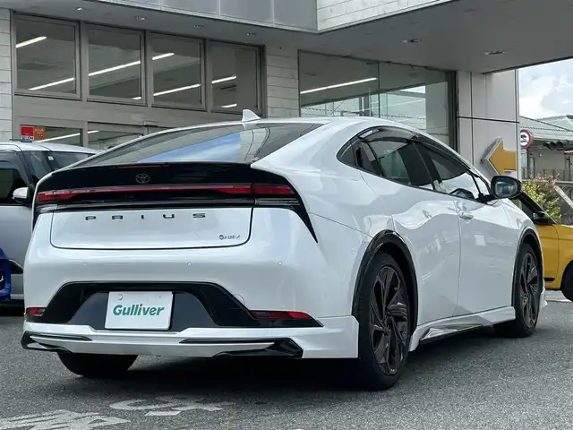 トヨタ プリウス Z 奈良県 2024(令6)年 1.6万km プラチナホワイトパールマイカ 1オーナー/モデリスタフルエアロ/モデリスタアルミ/純正メーカーナビ/TV/BT//アラウンドビューカメラ/追従式クルコン/コーナーセンサー/レーンキープアシスト/ETC2.0/バックカメラ/電動リアゲート/パワーシート/フルフラットシート/シートヒーター/エアシート/置くだけ充電/オートLEDライト/保証書・取説・スペアキー付