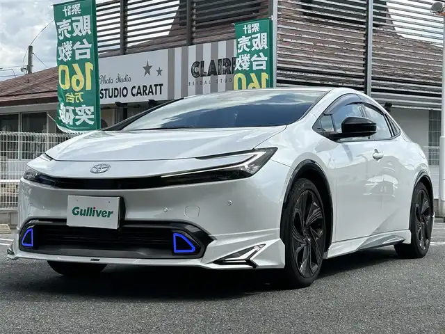 トヨタ プリウス Z 奈良県 2024(令6)年 1.6万km プラチナホワイトパールマイカ 1オーナー/モデリスタフルエアロ/モデリスタアルミ/純正メーカーナビ/TV/BT//アラウンドビューカメラ/追従式クルコン/コーナーセンサー/レーンキープアシスト/ETC2.0/バックカメラ/電動リアゲート/パワーシート/フルフラットシート/シートヒーター/エアシート/置くだけ充電/オートLEDライト/保証書・取説・スペアキー付