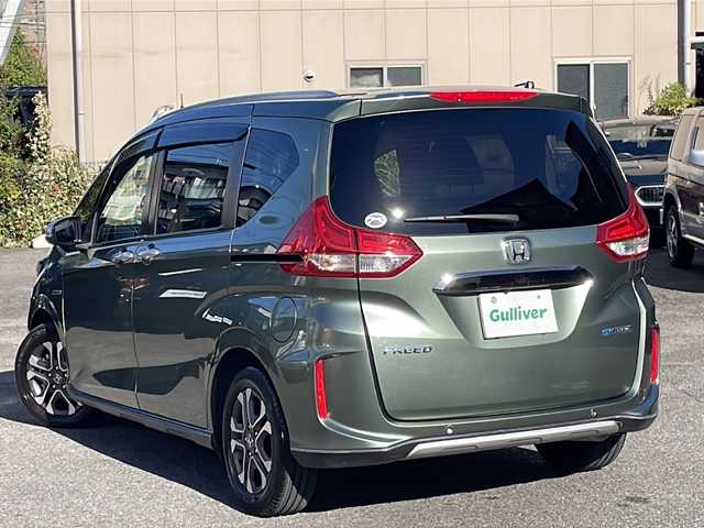 ホンダ フリード ハイブリット クロスター ホンダセンシング 愛知県 2022(令4)年 1.3万km シルバーミストグリーンM /禁煙車//ワンオーナー//純正ナビ【VXM-224VFi】//フルセグTV・DVD・Bluetooth//両側パワースライドドア//LEDヘッドライト+アクティブコーナリングライト//オートライト//CROSSTAR専用装備//ルーフレール//純正15インチアルミホイール//木目調インパネミドルエリア//コンビシート(プライムスムース×ファブリック)//Cパッケージ（ロールサンシェード、IRカット、コンフォートビューパッケージ、D/N席シートヒーター、プラズマクラスター技術搭載フルオートエアコン//HondaSENSING//衝突軽減ブレーキ//先行車発進お知らせ機能//歩行者事故低減ステアリング//路外逸脱抑制機能//アダプティブクルーズコントロール//レーンキープアシスト//誤発進抑制苦悩//後方誤発進抑制機能//電動格納式ウインカーミラー//オートリトラミラー//純正フロアマット//ステアリングスイッチ//ETC//オートライト//スペアキー//新車保証書//取扱説明書