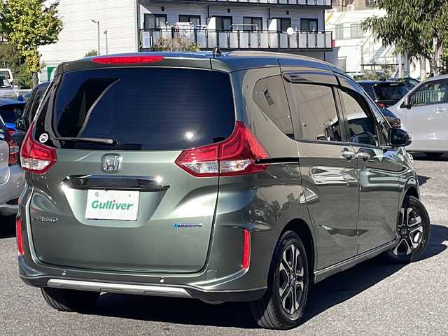 ホンダ フリード ハイブリット クロスター ホンダセンシング 愛知県 2022(令4)年 1.3万km シルバーミストグリーンM /禁煙車//ワンオーナー//純正ナビ【VXM-224VFi】//フルセグTV・DVD・Bluetooth//両側パワースライドドア//LEDヘッドライト+アクティブコーナリングライト//オートライト//CROSSTAR専用装備//ルーフレール//純正15インチアルミホイール//木目調インパネミドルエリア//コンビシート(プライムスムース×ファブリック)//Cパッケージ（ロールサンシェード、IRカット、コンフォートビューパッケージ、D/N席シートヒーター、プラズマクラスター技術搭載フルオートエアコン//HondaSENSING//衝突軽減ブレーキ//先行車発進お知らせ機能//歩行者事故低減ステアリング//路外逸脱抑制機能//アダプティブクルーズコントロール//レーンキープアシスト//誤発進抑制苦悩//後方誤発進抑制機能//電動格納式ウインカーミラー//オートリトラミラー//純正フロアマット//ステアリングスイッチ//ETC//オートライト//スペアキー//新車保証書//取扱説明書