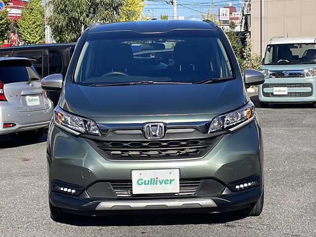 ホンダ フリード ハイブリット クロスター ホンダセンシング 愛知県 2022(令4)年 1.3万km シルバーミストグリーンM /禁煙車//ワンオーナー//純正ナビ【VXM-224VFi】//フルセグTV・DVD・Bluetooth//両側パワースライドドア//LEDヘッドライト+アクティブコーナリングライト//オートライト//CROSSTAR専用装備//ルーフレール//純正15インチアルミホイール//木目調インパネミドルエリア//コンビシート(プライムスムース×ファブリック)//Cパッケージ（ロールサンシェード、IRカット、コンフォートビューパッケージ、D/N席シートヒーター、プラズマクラスター技術搭載フルオートエアコン//HondaSENSING//衝突軽減ブレーキ//先行車発進お知らせ機能//歩行者事故低減ステアリング//路外逸脱抑制機能//アダプティブクルーズコントロール//レーンキープアシスト//誤発進抑制苦悩//後方誤発進抑制機能//電動格納式ウインカーミラー//オートリトラミラー//純正フロアマット//ステアリングスイッチ//ETC//オートライト//スペアキー//新車保証書//取扱説明書