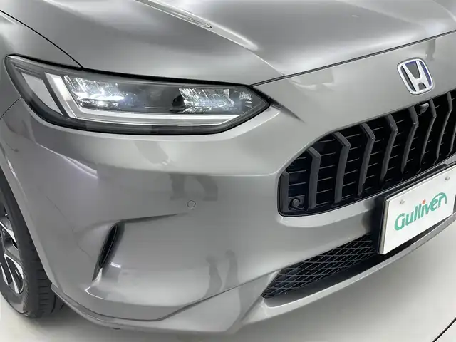 ホンダ ＺＲ－Ｖ ハイブリッド e:HEV Z 福井県 2022(令4)年 2.6万km スーパープラチナグレーメタリック ９インチHonda CONNECTナビ/フルセグTV/Bluetooth/AppleCarPlay/USB/AM/FM/マルチビューカメラシステム/ビルトイン2.0ETC/純正ドライブレコーダー/Honda SENSING/・衝突軽減ブレーキ/・誤発進抑制機能/・後方誤発進抑制機能/・歩行者事故低減ステアリング/・路外逸脱抑制機能/車線維持支援システム/・アダプティブクルーズコントロール/・標識認識機能/・先行車発進お知らせ機能/・オートハイビーム/・ブラインドスポットモニター/プッシュスタート /スペアキー/フルLEDヘッドライト（オートライト）/LEDアクティブコーナリングライト/BOSEプレミアムサウンドシステム/シートヒーター /ステアリングヒーター/ステアリングリモコン/パドルシフト/パワーバックドア/ワイヤレス充電器