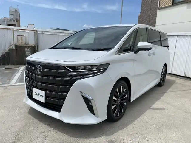 トヨタ アルファードハイブリット エグゼクティブ ラウンジ 広島県 2025(令7)年 0.1万km未満 プラチナホワイトパールマイカ ワンオーナー/トヨタチームメイト/ベージュプレミアムナッパ革シート/左右独立ムーンルーフ/純正OP:19インチアルミホイール/JBLプレミアムサウンドシステム/14インチリアエンターテイメント/14インチディスプレイオーディオプラス/エグゼクティブラウンジシート/デジタルインナーミラー/カラーヘッドアップディスプレイ/パノラミックビューカメラ/フルセグTV・スマートキー/保証書あり/取り扱い説明書あり/スペア（スマートキー）あり
