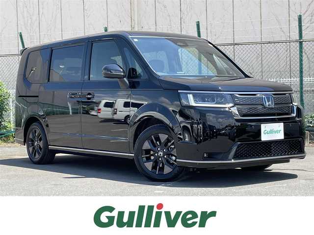 ホンダ ステップワゴン スパーダ eHEV 東京都 2025(令7)年 0.1万km未満 クリスタルブラックパール 純正ナビ/バックモニター/衝突軽減ブレーキ/路外逸脱抑制/ブラインドスポット/パーキングセンサー/レーダークルーズ/シートヒーター/両側電動スライドドア/電動リアゲート/ステアリングスイッチ