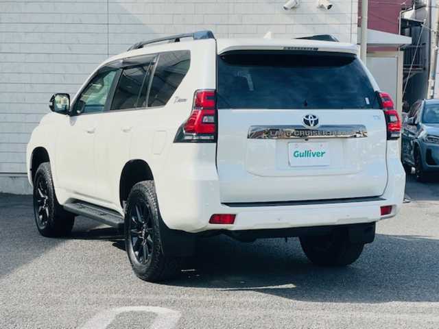トヨタ ランドクルーザー プラド TX-L 70thアニバーサリーLTD 大分県 2021(令3)年 3.9万km ホワイトパールクリスタルシャイン 「070」ホワイトパールクリスタルシャイン【MOP】/チルト＆スライド電動ムーンルーフ【MOP】/ルーフレール（専用ピアノブラック塗装）【MOP】/純正ナビ【MOP】/・フルセグTV/・Bluetooth/・ラジオ/・マルチテレインモニター/外部端子接続：USB/純正18インチAW（専用ブラック塗装）/純正フロアマット（70周年）【DOP】/純正エンブレム（70周年）【DOP】/電子インナーミラー/TOYOTAＳａｆｅｔｙsense/・プリクラッシュセーフティ/・レーンディパーチャーアラート/・オートマチックハイビーム/・レーダークルーズコントロール/・ロードサインアシスト/内装色サドルタン/・本革シート表皮/・スライド機能付き大型フロントアームレスト/・ドアトリムオーナメント/・センタークラスターサイドニーパット/ビルドインETC2.0/前後ドラレコ（ZDR035）/保証書/取説（車両/ナビ/オフロード走行）/スマートキー2本/前だけ2インチリフトアップしてます/標準防眩ミラーから電子インナーミラー（トヨタ純正品）交換済/ホーン交換済み（トヨタ純正品）
