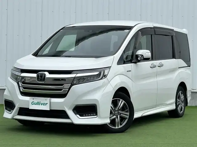 ホンダ ステップワゴン スパーダ ハイブリッド G ホンダセンシング 香川県 2018(平30)年 6.7万km プラチナホワイトパール 登録時走行距離：66111km/衝突被害軽減装置/純正9型ナビゲーション/→フルセグTV/→CD/DVD再生/バックカメラ/ビルトインETC/ドライブレコーダー/クルーズコントロール/ステアリングリモコン/革巻きステアリング/LECオートライト/フォグランプ/純正フロアマット/後席サンシェード/横滑り防止装置/レーンキープアシスト/盗難防止装置/スマートキー/スペアキー