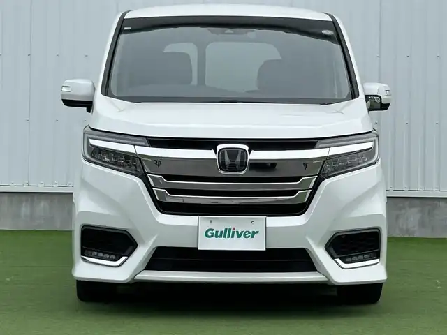 ホンダ ステップワゴン スパーダ ハイブリッド G ホンダセンシング 香川県 2018(平30)年 6.7万km プラチナホワイトパール 登録時走行距離：66111km/衝突被害軽減装置/純正9型ナビゲーション/→フルセグTV/→CD/DVD再生/バックカメラ/ビルトインETC/ドライブレコーダー/クルーズコントロール/ステアリングリモコン/革巻きステアリング/LECオートライト/フォグランプ/純正フロアマット/後席サンシェード/横滑り防止装置/レーンキープアシスト/盗難防止装置/スマートキー/スペアキー