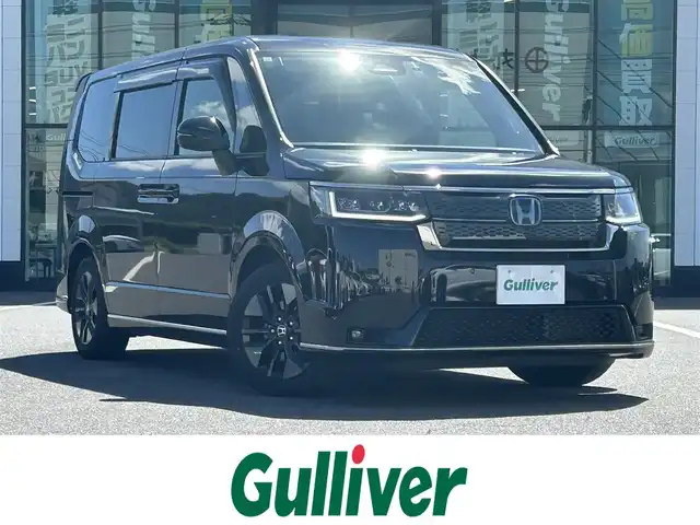 ホンダ ステップワゴン スパーダ eHEV 岡山県 2023(令5)年 4.1万km クリスタルブラックパール 純正11.4インチナビ/（AM.FM.BT.フルセグ.Carplay）/純正15.6インチフリップダウンモニター/バックカメラ/ビルトインETC/パワーバックドア/両側パワースライドドア/ホンダセンシング/・レーンディパーチャアラート/・レーダークルーズコントロール/・標識認識システム/・オートマチックハイビーム/ブラインドスポットモニター/ハーフレザーシート/D/N席シートヒーター/ドライブレコーダー/純正アルミホイール/LEDヘッドライト