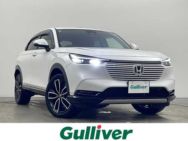 ホンダ ヴェゼル ハイブリッド e:HEV Z 秋田県 2021(令3)年 1.2万km プラチナホワイトパール ワンオーナー/ホンダコネクトナビ/・フルセグTV/BT/全方位カメラ、バックカメラ/純正前後ドライブレコーダー/ビルトインETC2.0/置くだけ充電/ホンダセンシング/・レーンキープ/・ブラインドスポットインフォメーション/・踏み間違い衝突軽減システム/・衝突軽減ブレーキ（CMBS）/ハーフレザーシート/・前席シートヒーター/コーナーセンサー/パワーバックドア/ステアリングヒーター/純正18インチAW/LEDヘッドライト/フォグランプ/スマートキー/横滑り防止装置/ドアバイザー/純正フロアマット/保証書/取扱説明書/スペアキー×1