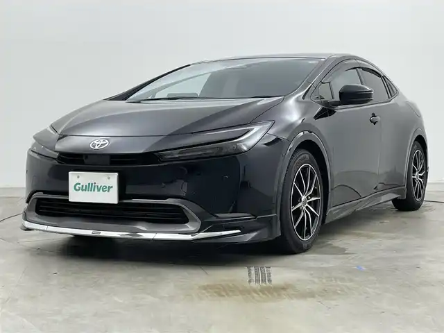 トヨタ プリウス 岡山県 2024(令6)年 1万km アティチュードブラックマイカ モデリスタエアロ　前・横・後下　/純正ディスプレイオーディオ/【BT/フルセグ/Carplay】/全方位カメラ　/レーダークルーズコントロール　/ＥＴＣ２．０　/シートヒーター　前席　/エアシート　前席　/ＬＥＤヘッドライト　/ワイヤレス充電　/デジタルインナーミラー　/ブラインドスポットモニター　/電動リアゲート/禁煙車/スペアキー×1/コーナーセンサー　前後/ステアリングヒーター/パーキングアシスト