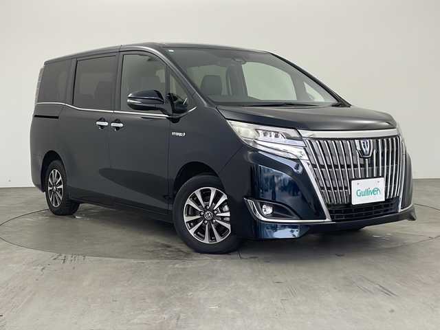 トヨタ エスクァイア ハイブリッド Gi 兵庫県 2019(平31)年 6万km ブラッキッシュアゲハガラスフレーク ・社外ナビ/CD/DVD/BT/USB/HDMI/TV/・社外リアフリップダウンモニター/・クルーズコントロール/・両側パワースライド/・LEDオートライト/・オートマチックハイビーム/・トヨタセーフティセンス/・プリクラッシュセーフティ/・レーンキープアシスト/・バックカメラ/・シートヒーター（運転席＋助手席）/・レザーシート/・ウォークスルー/・ETC/・スマートキー/・プッシュスタート/・コンビステアリング/・純正アルミホイール/・純正フロアマット/・AC100V充電/・WAC