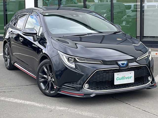 トヨタ カローラツーリング ハイブリッド ダブルバイビー 道東・釧路十勝 2021(令3)年 6.5万km ブラックマイカ ・寒冷地仕様/・純正ディスプレイオーディオ/　（AM　FM　TV　BT　Miracast）/・TRDフルエアロ/・トヨタセーフティセンス/・プリクラッシュセーフティ/・レーントレーシングアシスト/・レーンディパーチャーアラート/・レーダークルーズコントロール/・オートマチックハイビーム/・ロードサインアシスト/・ドライバー異常時対応システム/・プロアクティブドライビングアシスト/・発進遅れ告知機能/・純正スマートキー一体式エンジンスターター/・純正デジタルインナーミラー/・AC100V充電/・ETC2.0/・スマートキー2本
