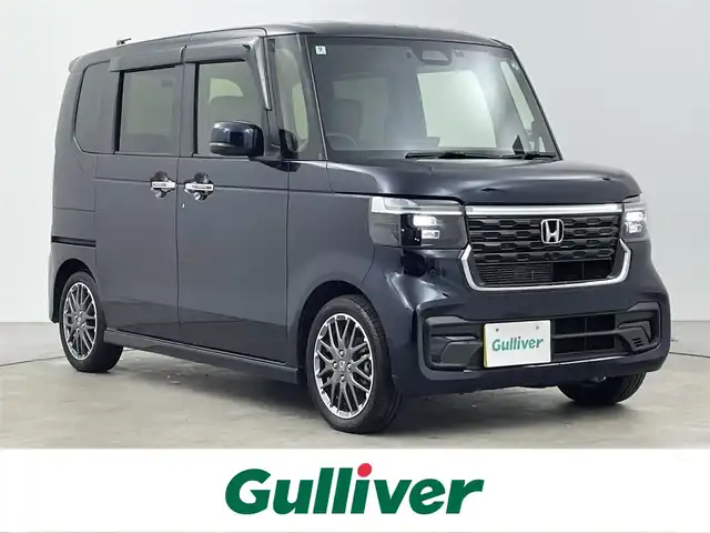 ホンダ Ｎ ＢＯＸ カスタム ターボ 大分県 2024(令6)年 2.2万km ミッドナイトブルービームM ホンダセンシング搭載/・衝突軽減ブレーキ/・先行車発進お知らせ機能/・歩行者事故低減ステアリング/・路外逸脱抑制制御機能/・標識認識機能/・渋滞追従機能付アダプティブクルーズコントロール/・車線維持支援システム/・誤発進抑制機能/・後方誤発進抑制機能/・近距離衝突軽減ブレーキ/・急アクセル抑制機能/・パーキングセンサーシステム/・オートハイビーム/マルチビューカメラシステム/純正9型ナビ　型式：LXU-242NBi/・フルセグTV、CD/DVD、BT対応、USB/・AppleCarPlay、AndroidAuto/ステアリングスイッチ/両側電動スライドドア/前後ドライブレコーダー　型式:DRH-229ND/ETC/ハーフレザーシート/・前席シートヒーター/パドルシフト/電動格納ミラー/純正フロアマット/オートライト/LEDヘッドライト/純正15インチアルミホイール/保証書、取説