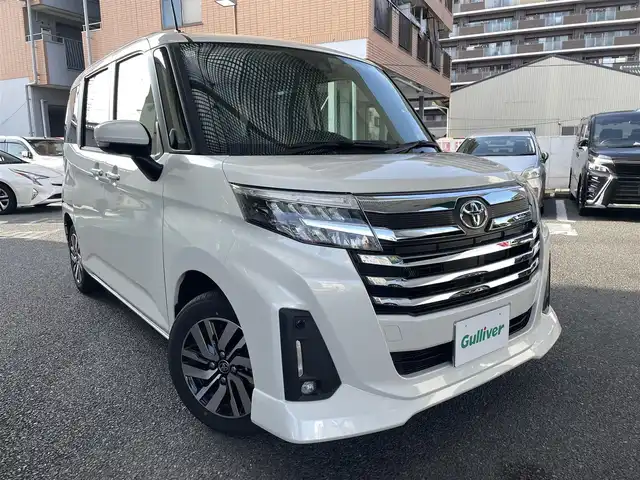 トヨタ ルーミー カスタムG 大阪府 2023(令5)年 1万km パールホワイトⅢ ワンオーナー/純正メモリーナビ/　フルセグTV/　Bluetooth/　DVD再生/　AM/FM/全方位カメラ/バックカメラ/スマートアシストIII/　衝突軽減ブレーキ/　車線逸脱警報/　先行車発信お知らせ/　ふらつき警報/　誤発進抑制制御/　オートハイビーム/レーダークルーズコントロール/純正ＬＥＤライト/スマートキー/両側パワースライドドア/フロントシートヒーター/ドラレコ/スペアキー1本（スマートキー）