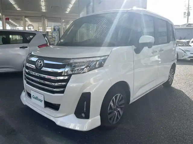 トヨタ ルーミー カスタムG 大阪府 2023(令5)年 1万km パールホワイトⅢ ワンオーナー/純正メモリーナビ/　フルセグTV/　Bluetooth/　DVD再生/　AM/FM/全方位カメラ/バックカメラ/スマートアシストIII/　衝突軽減ブレーキ/　車線逸脱警報/　先行車発信お知らせ/　ふらつき警報/　誤発進抑制制御/　オートハイビーム/レーダークルーズコントロール/純正ＬＥＤライト/スマートキー/両側パワースライドドア/フロントシートヒーター/ドラレコ/スペアキー1本（スマートキー）