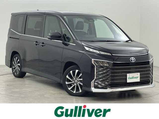 トヨタ ヴォクシー ハイブリッド S－Z 福岡県 2023(令5)年 2万km グリッターブラックガラスフレーク 純正１０．５型ＤＡナビ　/全方位カメラ　/ビルトインＥＴＣ２．０　/トヨタセーフティセンス　/レーダークルーズコントロール　/コーナーセンサー　/衝突軽減ブレーキ　/レーンキープ　/アクセル踏み間違い防止　/ＢＳＭ　/パーキングアシスト　/シートヒーター　/ハーフレザーシート　/両側パワースライドドア　/Wエアコン　/純正アルミホイール