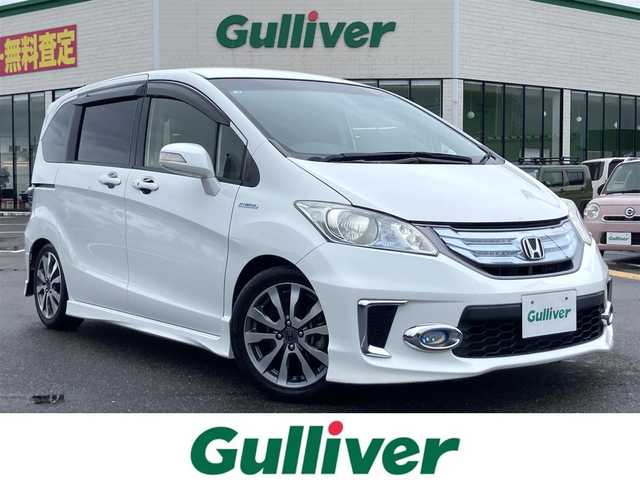 ホンダ フリード ハイブリット ジャストセレクション+ 鳥取県 2014(平26)年 6.7万km ホワイトオーキッドパール 純正ナビ/CD/DVD/BT/USB/バックカメラ/ビルトインETC/前後ドライブレコーダー/両側パワースライドドア/TEIN車高調/クルーズコントロール/キセノンヘットライト/フォグライト/純正16インチアルミホイール/純正エアロパーツ/ハーフレザーシートカバー/スマートキー×２/純正フロアマット/ドアバイザー/スタットレスセット積み込み/(タイヤ溝5部山）