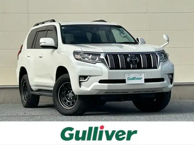 トヨタ ランドクルーザー プラド TX Lパッケージ 茨城県 2018(平30)年 6.9万km ホワイトパールクリスタルシャイン 純正ナビ　NZST-Y66T/　(AM/FM/フルセグ/Bluetooth)/バックカメラ/4WD/サンルーフ/7人乗り/ビルドインETC2.0/純正ドライブレコーダー/レーダークルーズコントロール/クリアランスソナー/革巻きステアリング/黒革シート/シートヒーター/シートエアコン/パワーシート/電動格納サードシート/ルーフレール/カーテンエアバッグ/LEDヘッドライト/オートマチックハイビーム/衝突被害軽減/レーンキープアシスト/スマートキー
