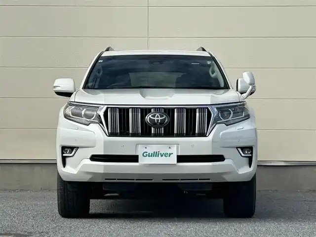 トヨタ ランドクルーザー プラド TX Lパッケージ 茨城県 2018(平30)年 6.9万km ホワイトパールクリスタルシャイン 純正ナビ　NZST-Y66T/　(AM/FM/フルセグ/Bluetooth)/バックカメラ/4WD/サンルーフ/7人乗り/ビルドインETC2.0/純正ドライブレコーダー/レーダークルーズコントロール/クリアランスソナー/革巻きステアリング/黒革シート/シートヒーター/シートエアコン/パワーシート/電動格納サードシート/ルーフレール/カーテンエアバッグ/LEDヘッドライト/オートマチックハイビーム/衝突被害軽減/レーンキープアシスト/スマートキー