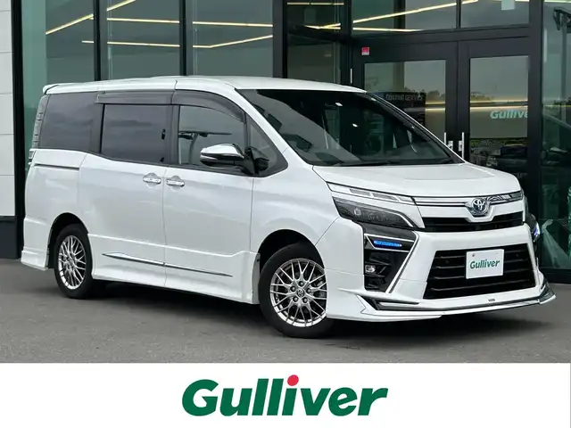 トヨタ ヴォクシー ハイブリッド ZS 煌Ⅲ 東京都 2021(令3)年 5.1万km ホワイトパールクリスタルシャイン セーフティセンス/・プリクラッシュセーフティ/・レーンキープアシスト/・オートハイビーム/・インテリジェントクリアランスソナー/純正10.5型ナビ（NSZN-Z68T）/バックカメラ/・CD/DVD/BT/AM/FM/・HDMI×USB/ミラーリング/TV/クルーズコントロール/ハーフレザーシート/・前席シートヒーター/両側パワースライドドア/リアロールサンシェード/トラクションコントロール/モデリスタフルエアロ/シグネチャーイルブレード/LEDヘッドライト/フォグ/ビルトインETC/保証書・取説・スペアキー