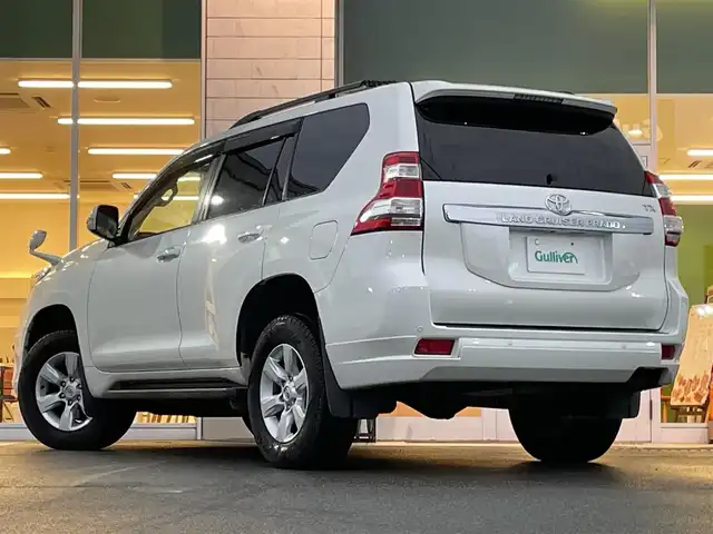 トヨタ ランドクルーザー プラド TX Lパッケージ 兵庫県 2015(平27)年 13万km ホワイトパールクリスタルシャイン モデリスタエアロ/サンルーフ/DN席シートヒーター/３列目電動シート/クルーズコントロール/ビルトインETC/純正アルミホイール/Bluetooth接続/ダウンヒルアシストコントロール/４WD/社外メモリナビ/オートマチックハイビーム/ヘッドライトウォッシャー/フルセグTV/スペアキー/スイッチスタート