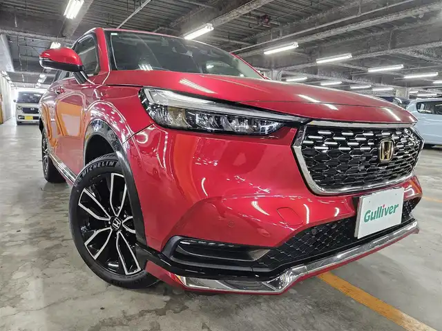 ホンダ ヴェゼル ハイブリッド e:HEV Z 秋田県 2021(令3)年 5.2万km プレミアムクリスタルレッドM 〇ワンオーナー/〇４WD/〇純正9インチナビ/〇フルセグTV/〇バックカメラ/〇純正ETC2.0/〇ドライブレコーダー/〇追従機能付クルーズコントロール/〇コーナーセンサー/〇ホンダセンシング/〇ブラインドスポットインフォメーション/〇LEDヘッドランプ/〇LEDフロントフォグランプ/〇ホンダコネクトディスプレイ/〇革巻きステアリングホイール/〇パドルシフト/〇左右独立温度調整オートエアコン/〇ブラックハーフレザーシート/〇前席シートヒーター/〇純正フロアマット/〇OPグリル/〇純正エアロ（F/S/R）/〇純正18インチアルミ/〇スマートキー/プッシュスタート/〇禁煙車