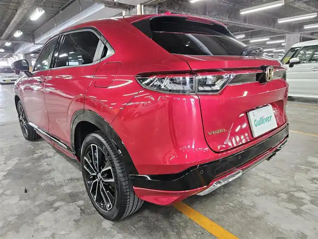 ホンダ ヴェゼル ハイブリッド e:HEV Z 秋田県 2021(令3)年 5.2万km プレミアムクリスタルレッドM 〇ワンオーナー/〇４WD/〇純正9インチナビ/〇フルセグTV/〇バックカメラ/〇純正ETC2.0/〇ドライブレコーダー/〇追従機能付クルーズコントロール/〇コーナーセンサー/〇ホンダセンシング/〇ブラインドスポットインフォメーション/〇LEDヘッドランプ/〇LEDフロントフォグランプ/〇ホンダコネクトディスプレイ/〇革巻きステアリングホイール/〇パドルシフト/〇左右独立温度調整オートエアコン/〇ブラックハーフレザーシート/〇前席シートヒーター/〇純正フロアマット/〇OPグリル/〇純正エアロ（F/S/R）/〇純正18インチアルミ/〇スマートキー/プッシュスタート/〇禁煙車